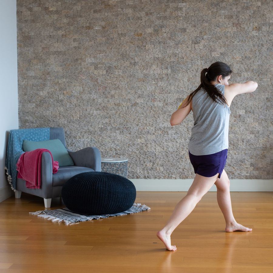 Millennial woman practicing martial arts at home