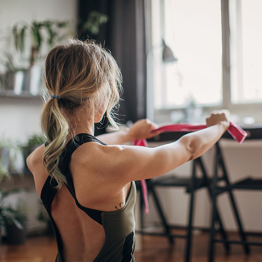 Woman performing a resistance band back workout
