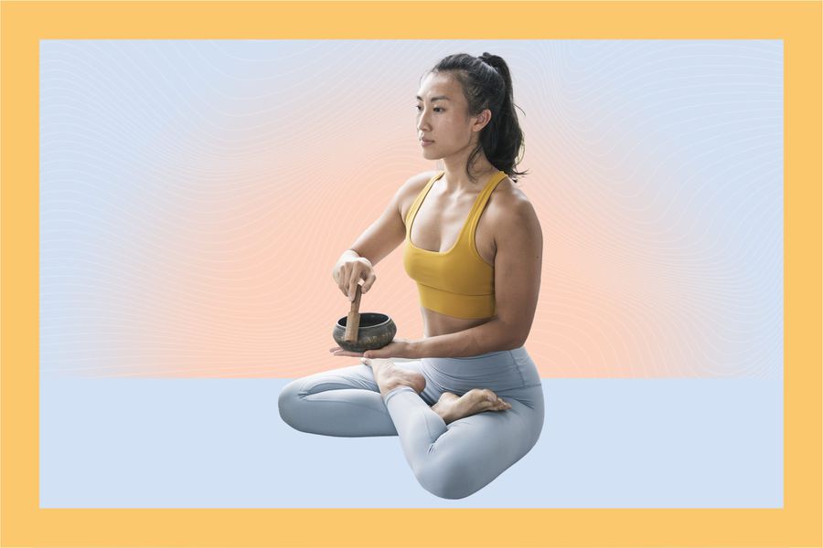 woman meditates with a singing bowl