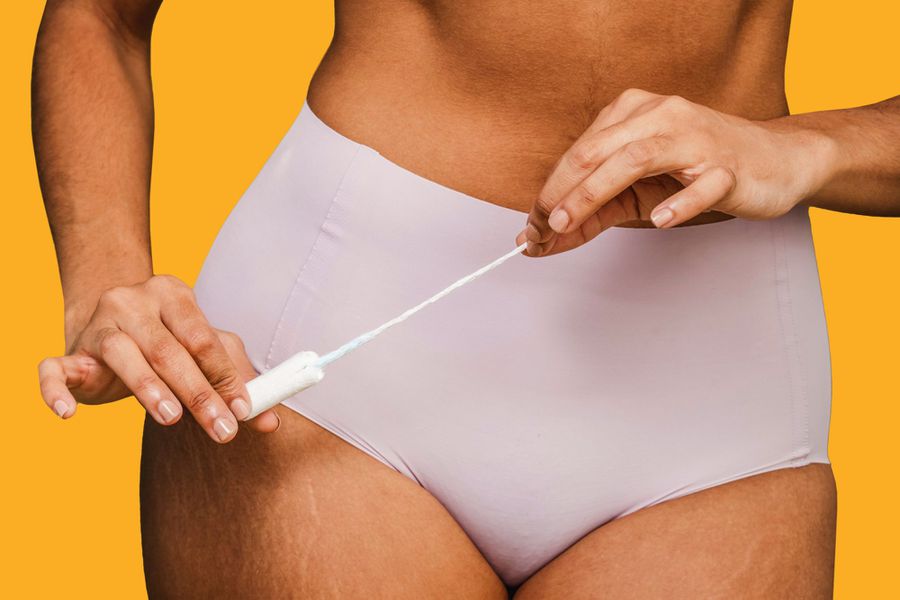 Woman in underwear preparing for using female tampon