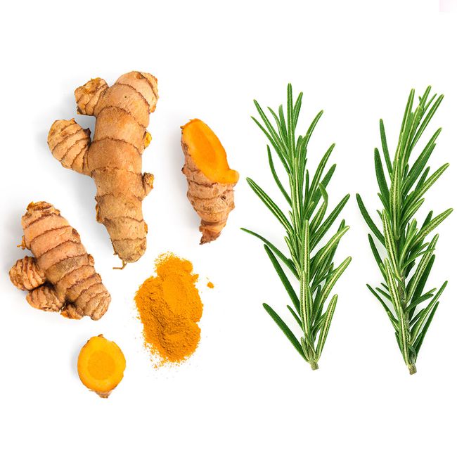 turmeric rosemary foods to help with bloating: turmeric root, turmeric powder, and two sprigs of rosemary shot overhead on a white background