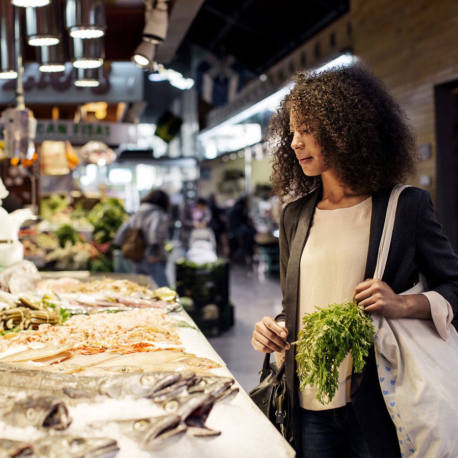 woman looking at seafood at a market