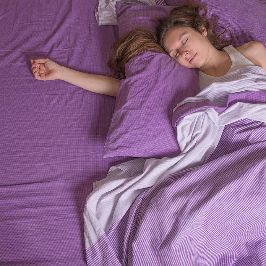 woman-sleeping-purple-sheets.jpg