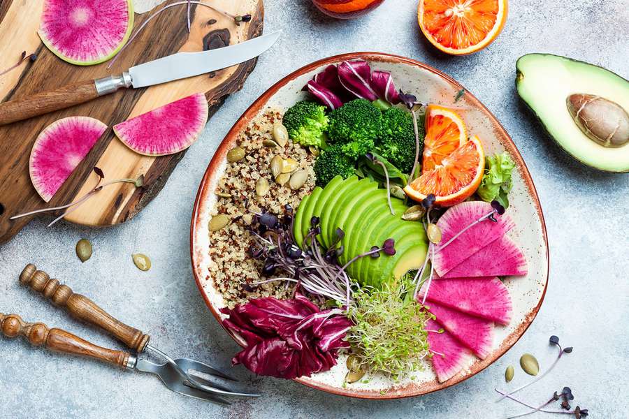 A grain bowl with quinoa, avocado, greens, and more