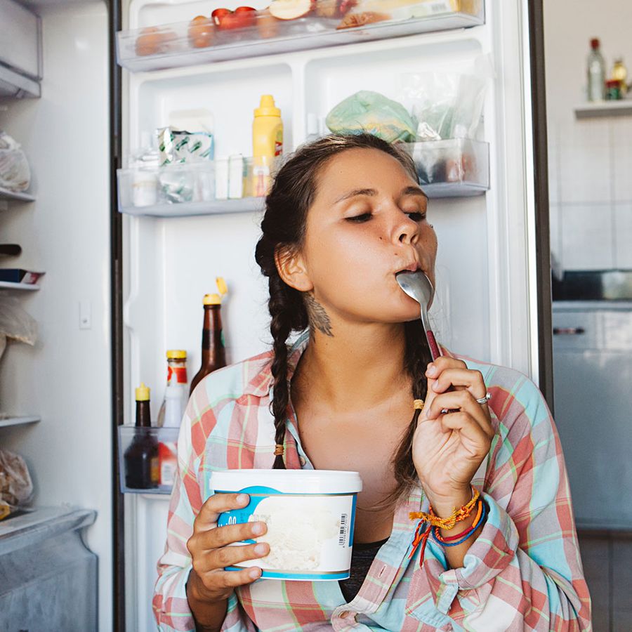 woman eating healthy ice cream pint out of the freezer