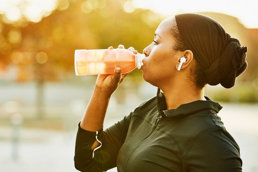 Woman Drinking from Plastic Bottle