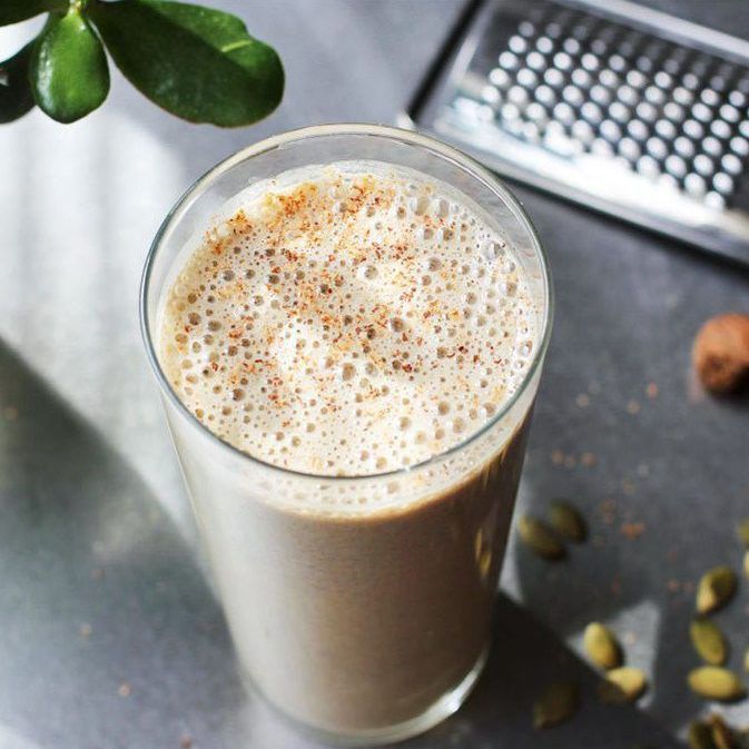 photograph of a healthy banana smoothie with nuts and seeds