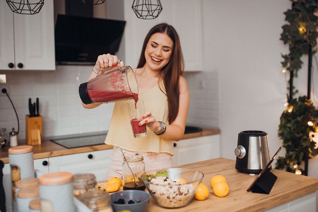 Young woman preparing a smoothie