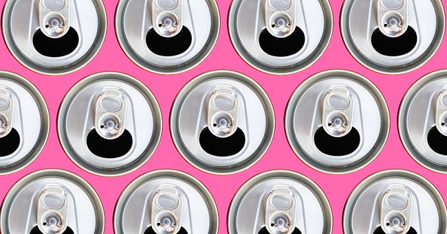 an overhead shot of the tops of multiple opened soda cans on a bright pink background